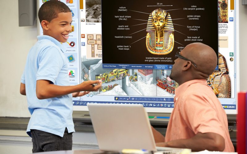 Male Student Writing Answer On Whiteboard